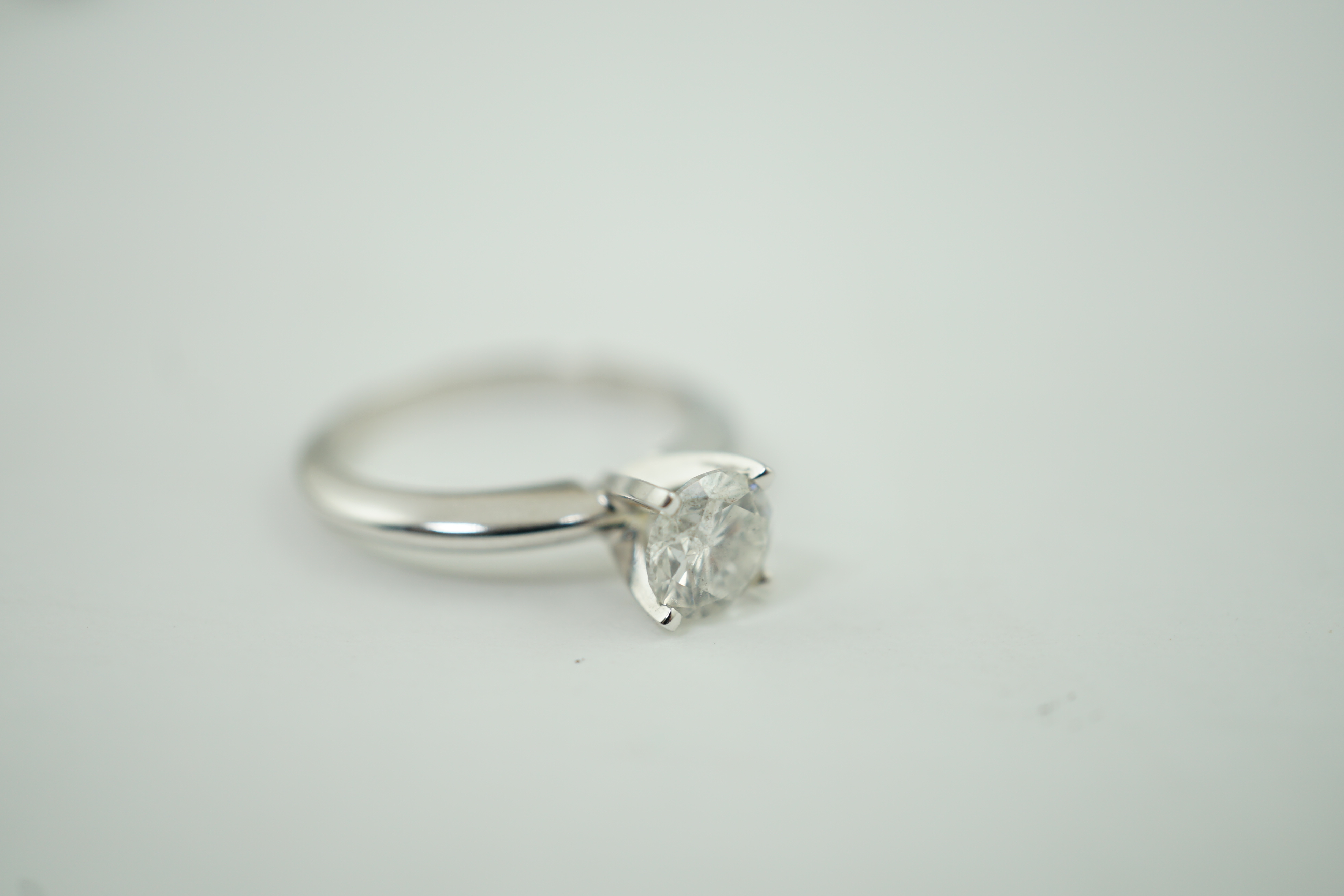 A modern 14k gold and solitaire diamond set ring